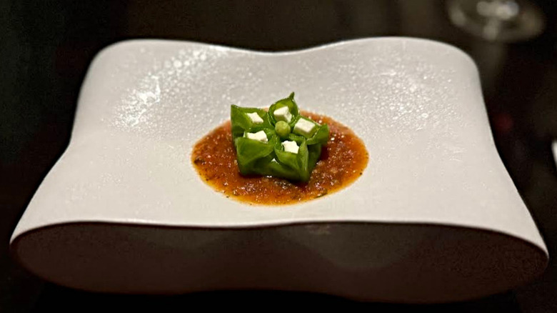 Momo dish with green peas, ricotta, and tomato sauce at Gaggan Anand
