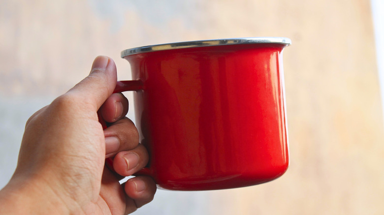 Person holding a mug