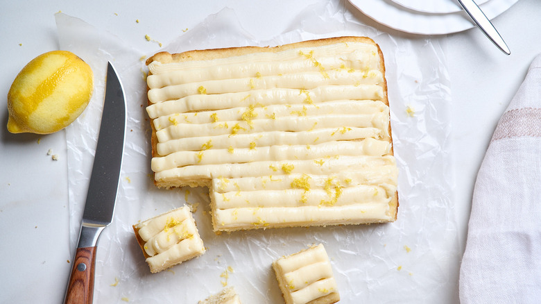 lemon sheet cake sliced on a table