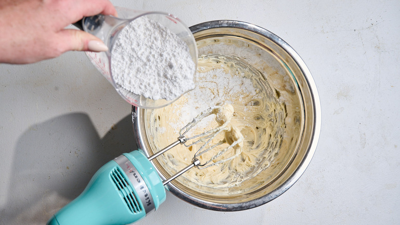 adding sugar to cream cheese mixture