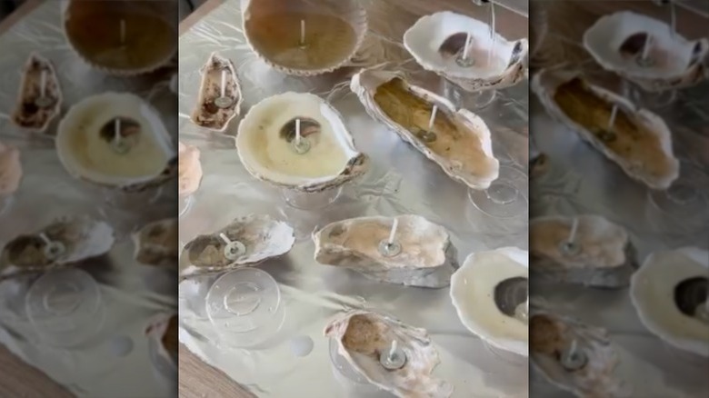 Oyster shell candles on wooden surface