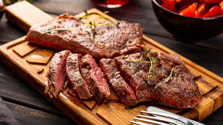 Grilled steak on wooden board