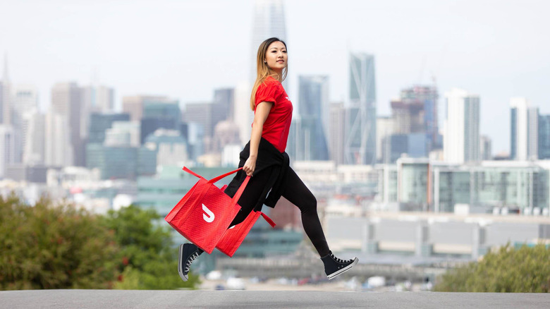 DoorDash delivery person crossing street