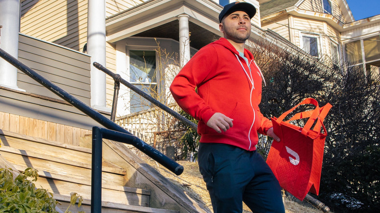 DoorDash delivery person descending steps