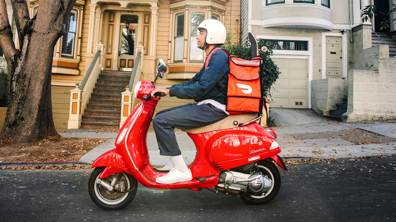 DoorDash delivery person on scooter