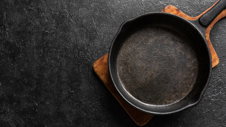 Empty cast iron pan on cutting board