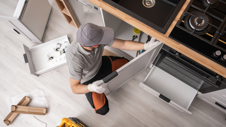 person on ground remodeling kitchen