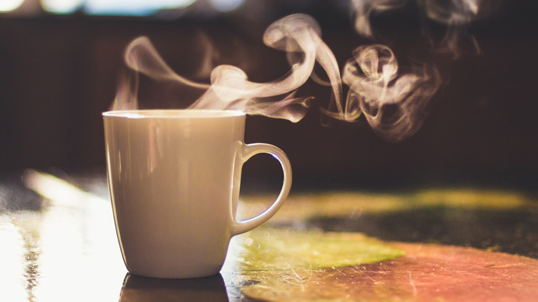Sunlit steam rising off of a mug