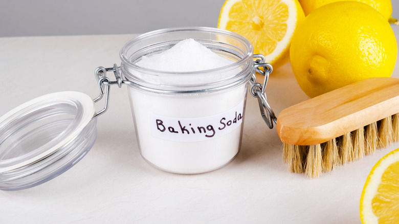 Baking soda in a jar with a scrub brush