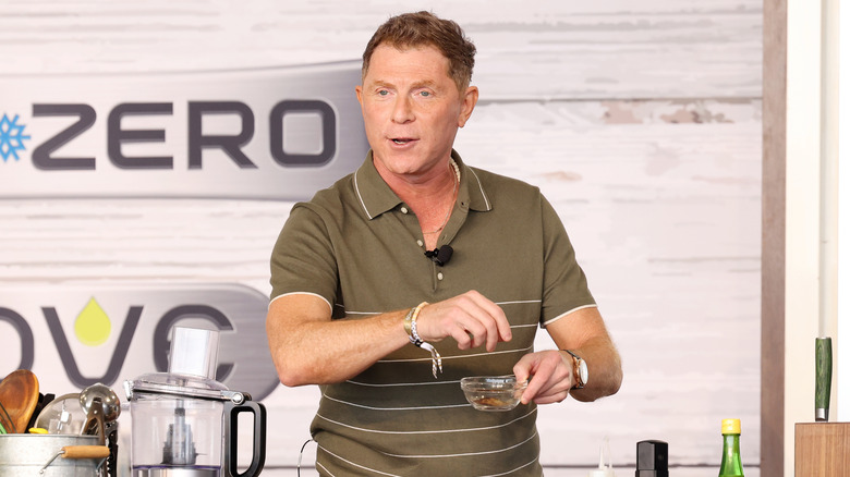 Bobby Flay prepping food at an event