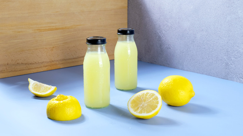 lemon juice bottles with lemons