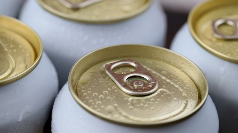 tops of cold canned beer sweating