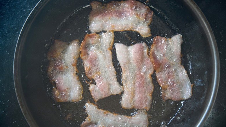 Bacon cooking inside a pot
