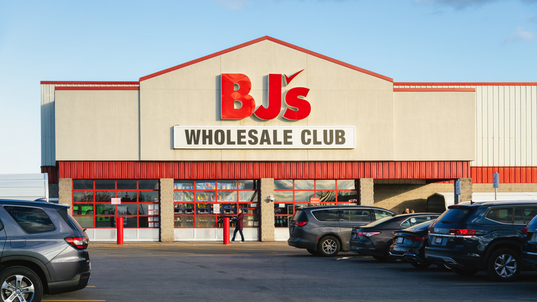 Exterior of a BJ's Wholesale Club location with cars in the parking lot