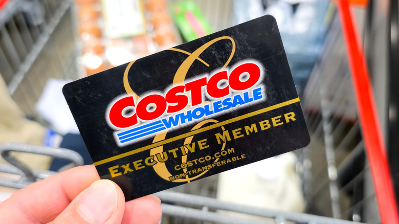 Costco executive membership card with a blurred shopping cart in the background