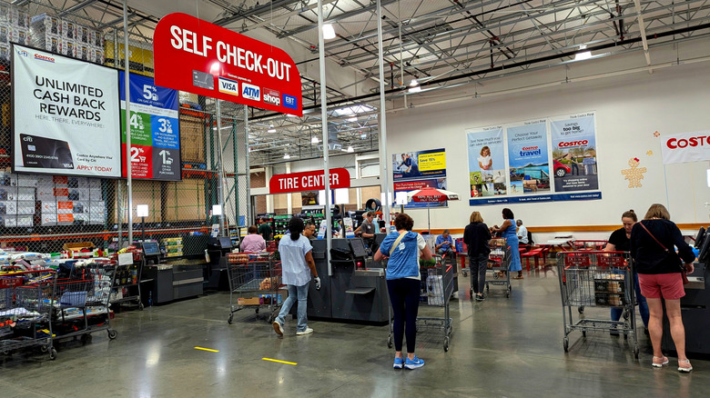 Shoppers going through the self check-out in a Costco store