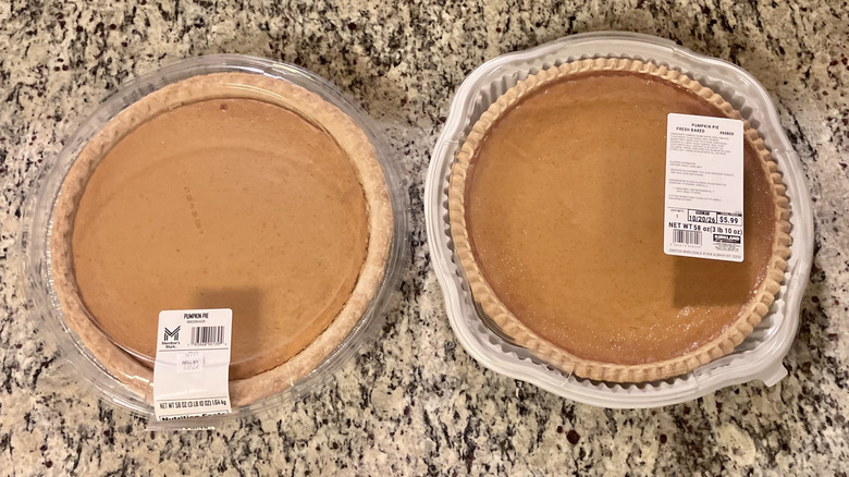 Sam's Club's Members Mark Pumpkin Pie sits on a counter next to Costco's Kirkland Signature Pumpkin Pie