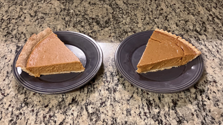 A slice of Sam's Club's Members Mark Pumpkin sits on a purple plate next to Costco's Kirkland Signature Pumpkin Pie that's on another purple plate