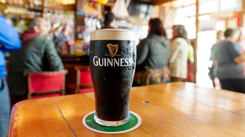 A pint of Guinness on a table in a pub in Ireland