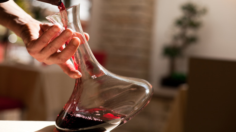pouring wine into decanter