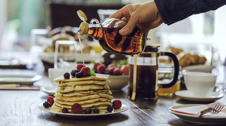 maple syrup on a stack of pancakes