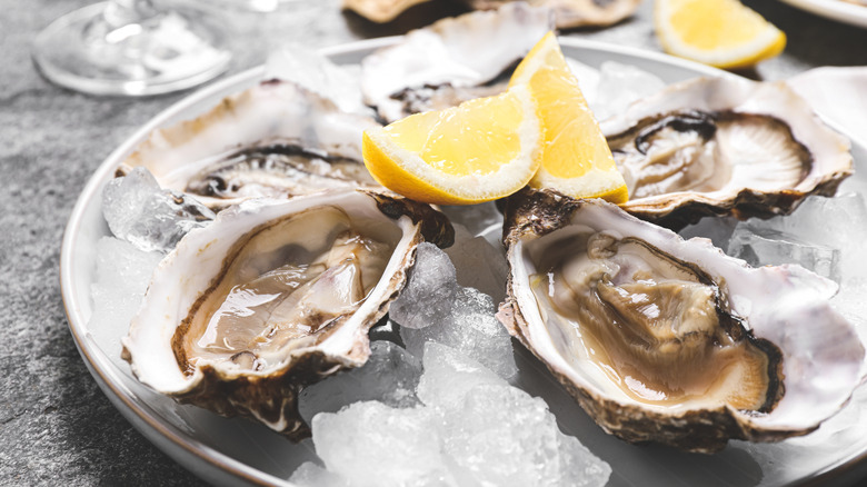 A dozen oysters on the half shell served on ice with sauces