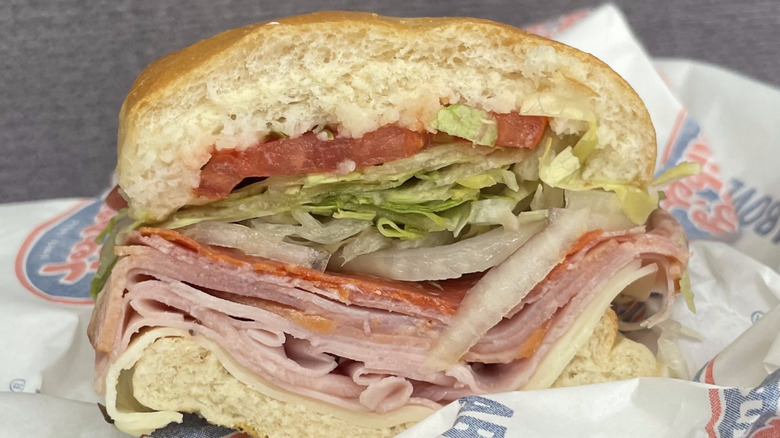 Half a Jersey Mike's Italian sub on branded paper