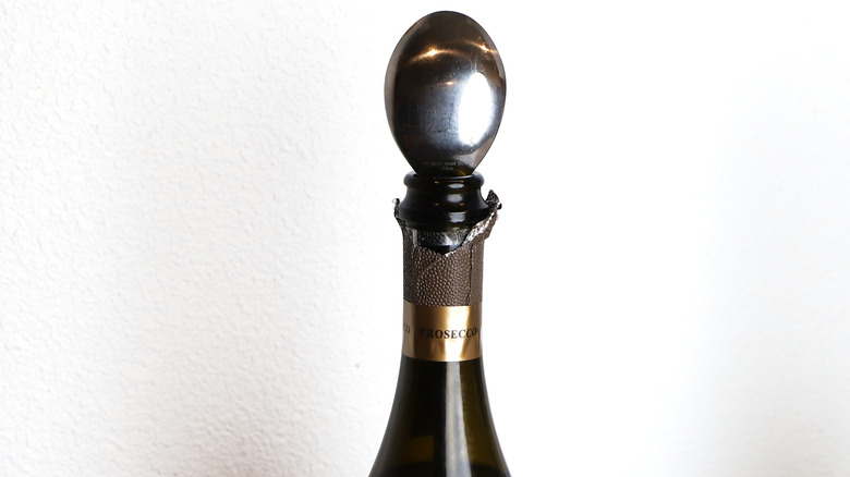 Bottle of sparkling with spoon 