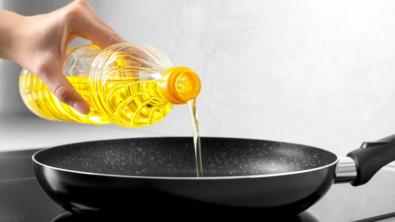vegetable oil pouring into pan