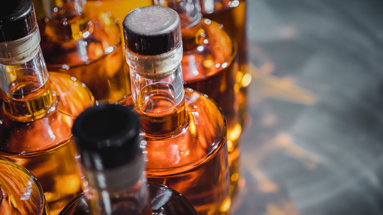 Close-up of tops of alcohol bottles