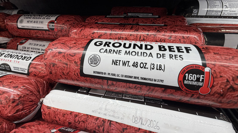 Tubes of ground beef for sale in a Walmart cooler.