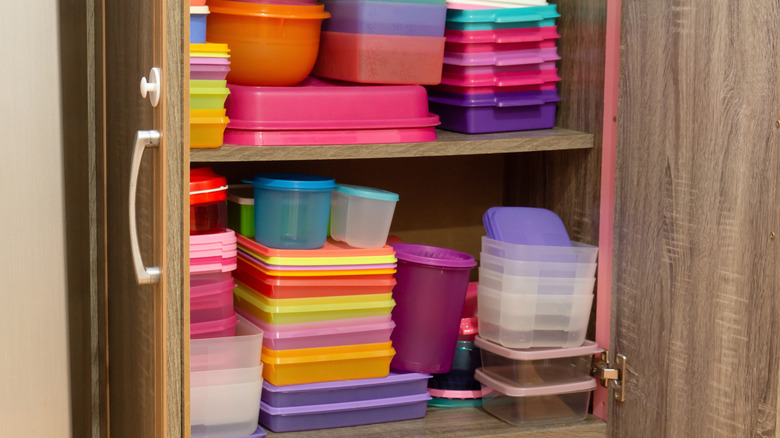 plastic containers in cupboard