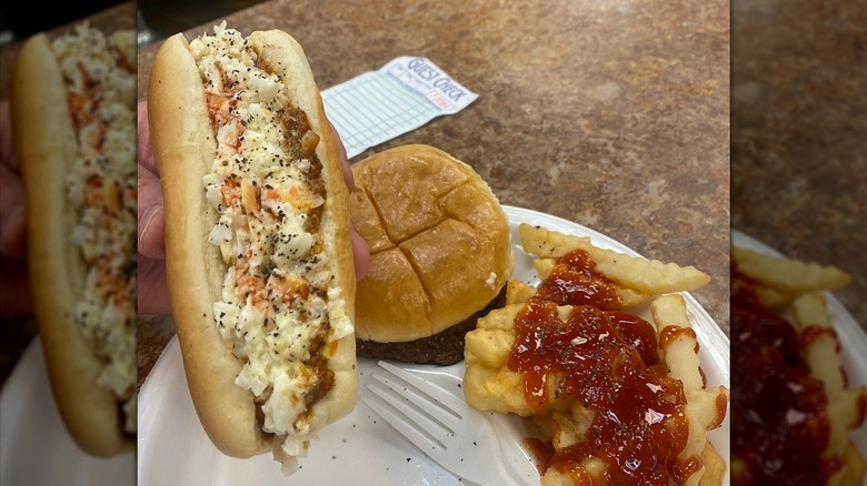 Frank Allen's Slaw Dog beside fries with ketchup and a hamburger