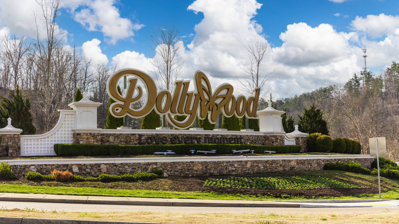 A golden sign with white pillars reads, 