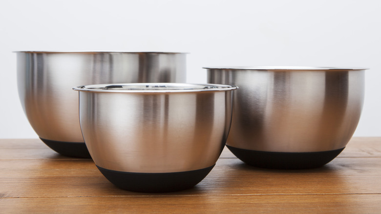 selection of metal mixing bowls on wood table