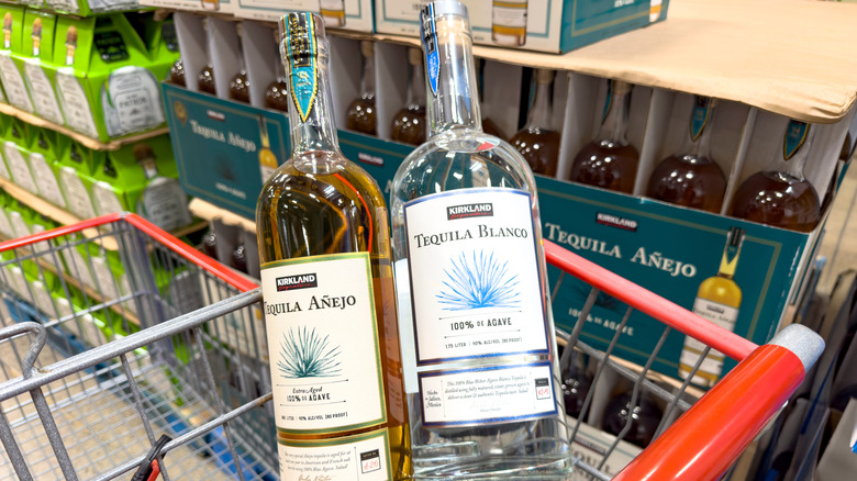 Two bottles of Kirkland Signature Blanco and Añejo tequilas in a cart