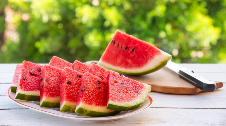 Closeup of a cut-up watermelon on a table outside