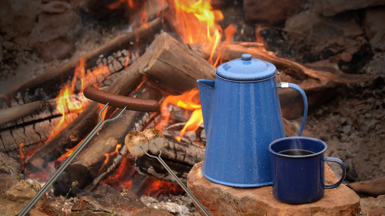 enamel coffee pot and mug by campfire