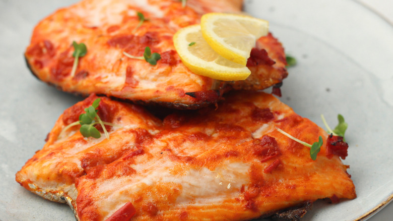harissa baked salmon on a white plate