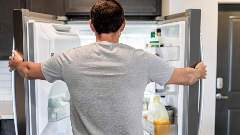 Man looking inside his fridge