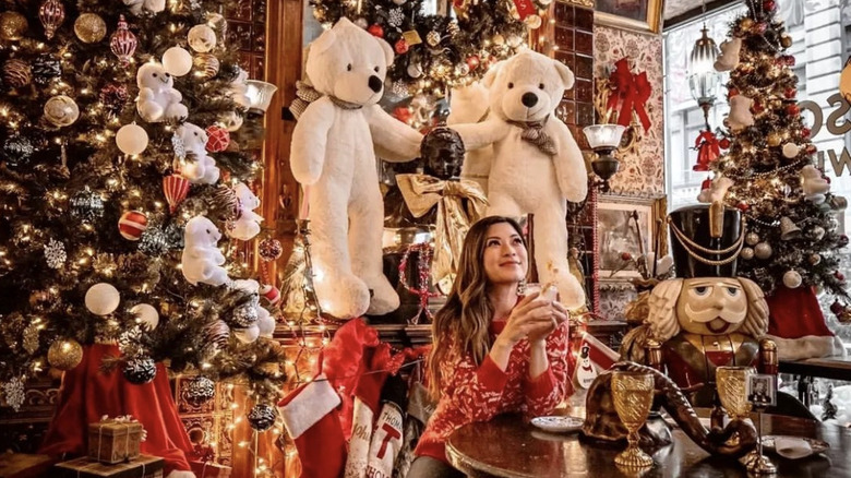 Woman enjoying a drink at Oscar Wilde during Christmas event.