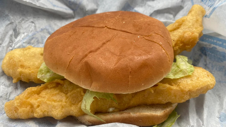 A Giant Fish Sandwich from Captain D's featuring two filets in a bun with lettuce.