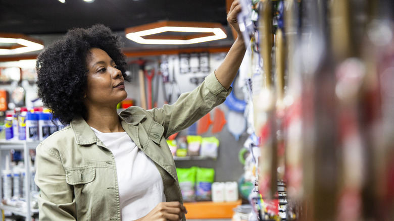 A woman looking through shelves at a hardware store