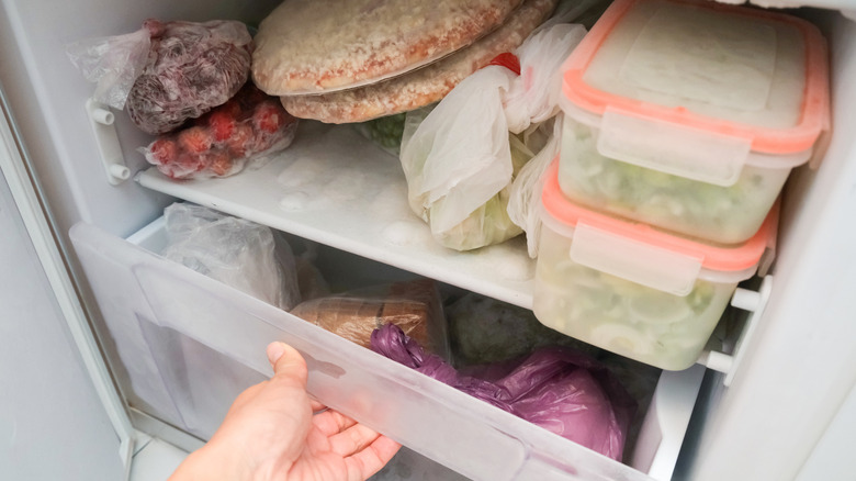Closeup of person opening freezer drawer