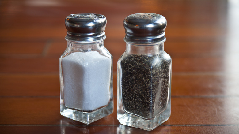 Salt and pepper shakers on table