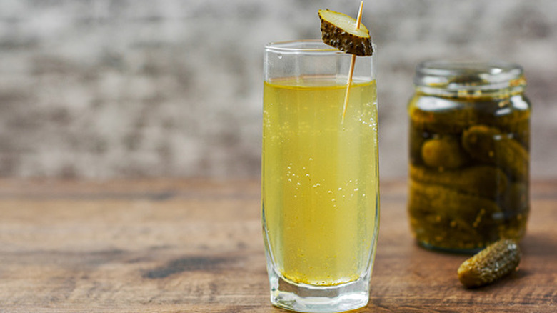 jar of pickles and glass of pickle juice