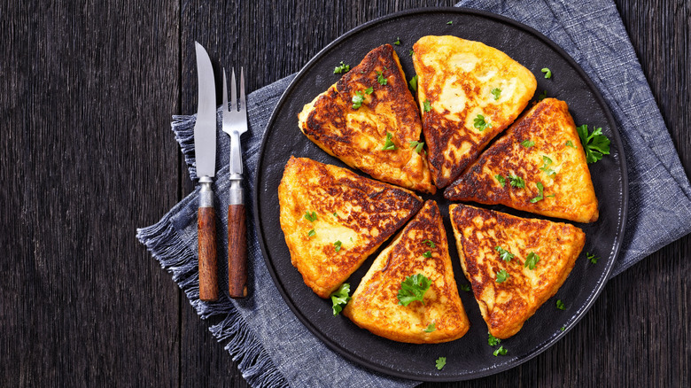 Irish potato cakes on a dark plate with parsley garnish