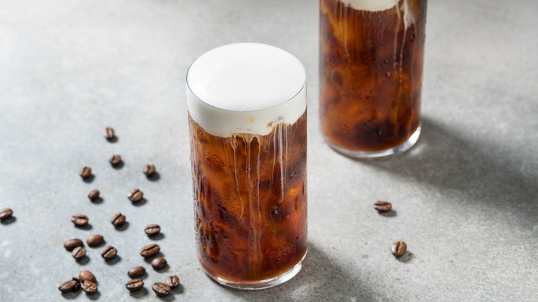Two glasses of coffee topped with cold foam