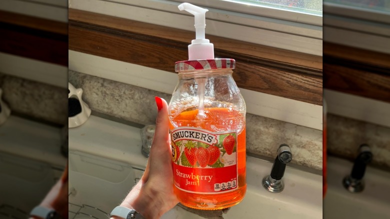woman holding homemade soap dispenser