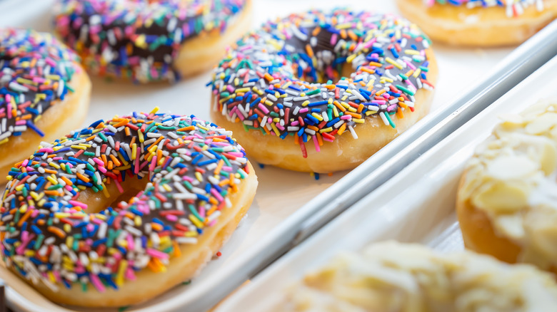 Closeup of fresh donuts on baking trays